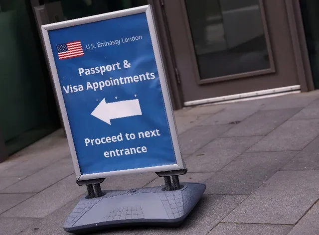 FILE PHOTO: An information sign for passport and visa appointments is displayed outside the U.S. embassy in London, Britain, May 29, 2025. REUTERS/Hannah McKay/File Photo