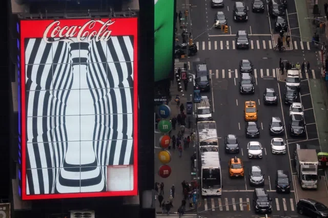 Traffic passes a Coca-Cola digital billboard in the Times Square area of Manhattan in New York City, U.S. March 2, 2023. REUTERS/Chris Helgren