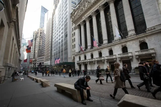 People walk by the New York Stock Exchange in New York's financial district March 11, 2014. REUTERS/Brendan McDermid (UNITED STATES - Tags: BUSINESS)