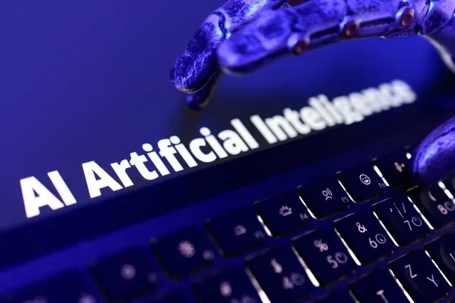 FILE PHOTO: Words "AI Artificial Inteligence", keyboard, and a robotic hand in this illustration taken June 5, 2026. REUTERS/Dado Ruvic