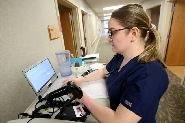 FILE PHOTO: A nurse updates a patient's chart on a laptop in Sylvania, Ohio, U.S., May 14, 2018. REUTERS/Aaron Josefczeyk/File Photo