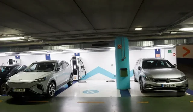 An MG Marvel R electric vehicle (EV) from MG, a brand of Chinese state-owned carmaker SAIC, is plugged in at a charging station in a car park in Bilbao, alongside a Volkswagen Passat, Spain, December 18, 2024. REUTERS/Vincent West