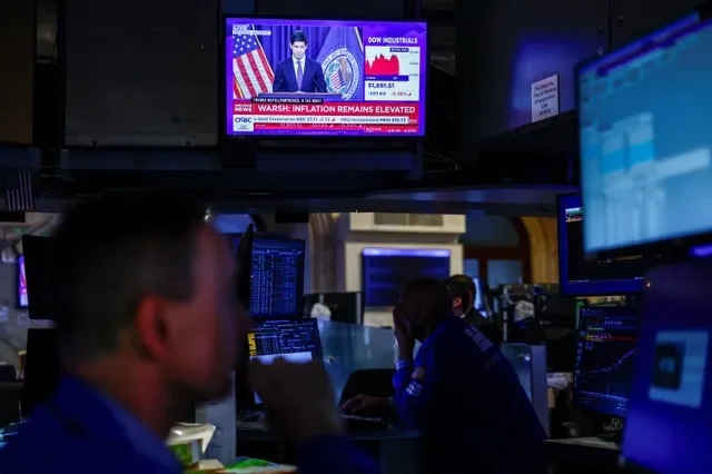 Traders work as screens broadcast a press conference by U.S. Federal Reserve Chair Kevin Warsh following the Fed rate announcement, on the floor of the New York Stock Exchange in New York City, U.S., September 16, 2026.