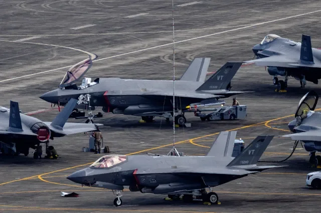 FILE PHOTO: Personnel work on U.S. Air Force F-35 Lightning II fighter jets parked on the tarmac at the former Roosevelt Roads naval base in Ceiba, Puerto Rico, January 3, 2026. REUTERS/Eva Marie Uzcategui/File Photo