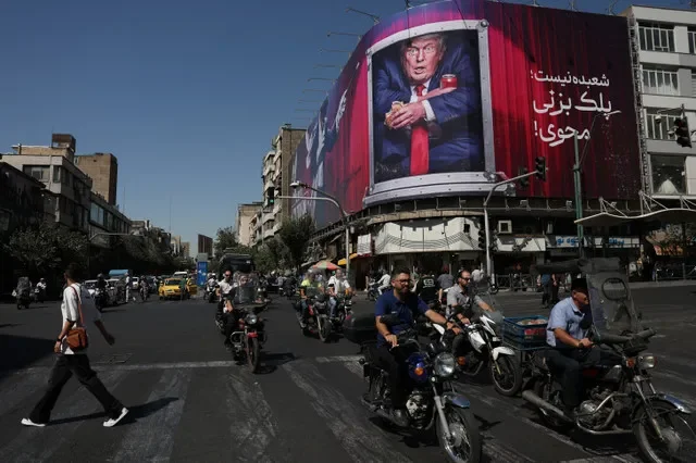 People drive near a billboard depicting U.S. President Donald Trump on a building in Tehran, Iran, September 16, 2026. Majid Asgaripour/WANA (West Asia News Agency) via REUTERS