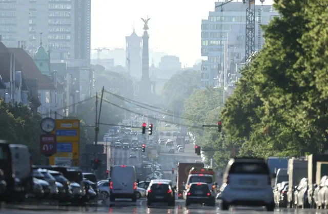 Vehicles move along during the early morning rush hour as sunrise haze illuminates the skyline in Berlin, Germany, June 24, 2026. REUTERS/Fabrizio Bensch