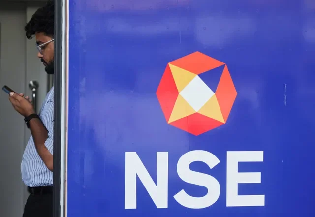 A commuter uses his phone inside a Mumbai Metro train displaying the National Stock Exchange (NSE) logo ahead of the exchange's planned initial public offering (IPO), in Mumbai, India, September 23, 2026. REUTERS/Francis Mascarenhas