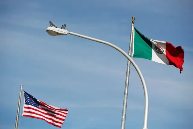 The US flag (L), and the Mexico's flag are pictured on the international border bridge Paso del Norte in between El Paso US and Ciudad Juarez in Ciudad Juarez, Mexico December 28, 2016. REUTERS/Jose Luis Gonzalez
