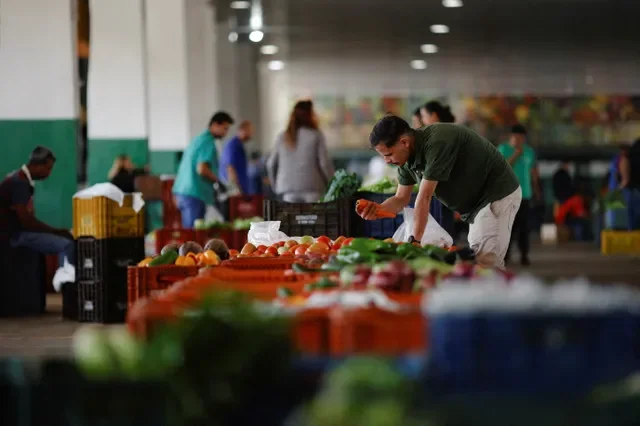 A salesman is seen at his vegetable stand at the supply centre (CEASA) in Brasilia, Brazil May 9, 2023. REUTERS/Adriano Machado REFILE - QUALITY REPEAT