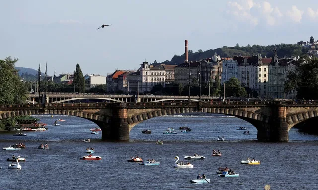 FILE PHOTO: People ride pedal boats on the Vltava river in Prague, Czech Republic, June 22, 2020. REUTERS/David W Cerny/File Photo