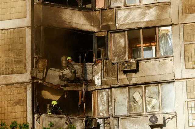 Firefighters work at the site of a residential building hit during a Russian jet-powered drone strike, amid Russia's attack on Ukraine, in Kyiv, Ukraine, September 27, 2026. REUTERS/Valentyn Ogirenko