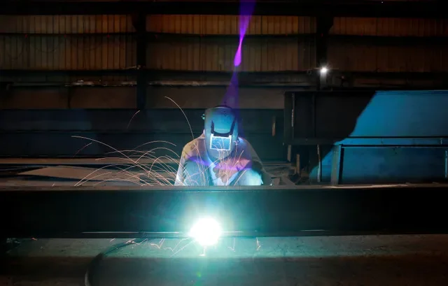 A labourer welds an iron pillar at a building material factory in an industrial area in Dasna, in the central Indian state of Uttar Pradesh, India, January 9, 2019. REUTERS/Adnan Abidi
