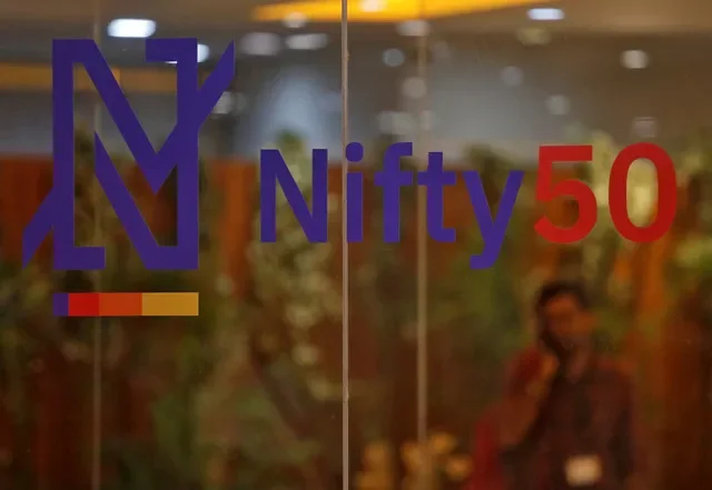 A man speaks on his mobile phone past a new brand identity for Nifty Indices inside the National Stock Exchange (NSE) building in Mumbai, India, May 28, 2019. REUTERS/Francis Mascarenhas