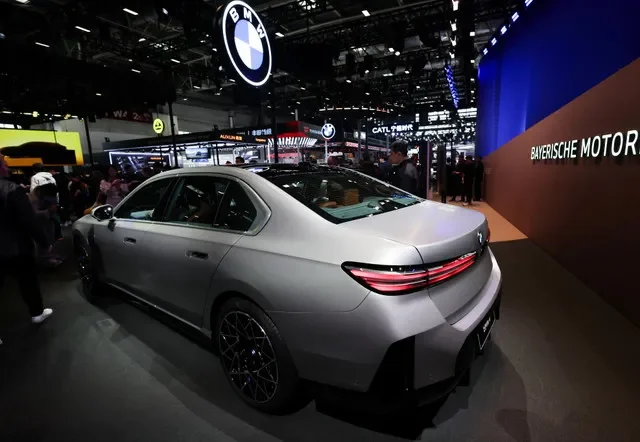People gather next to the BMW i7 electric sedan at the company’s booth at the Beijing International Automotive Exhibition (Auto China), in Beijing, China, April 24, 2026. REUTERS/Maxim Shemetov