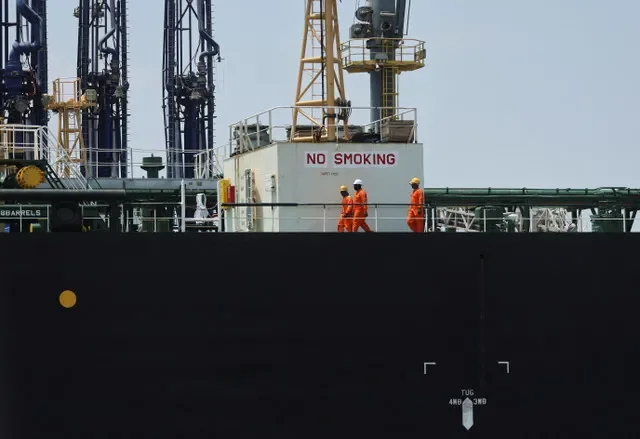 FILE PHOTO: Workers aboard the India-flagged tanker Desh Garima, as it unloads crude oil at an offloading terminal after transiting the Strait of Hormuz, amid supply disruptions linked to the U.S.-Israeli conflict with Iran, in Mumbai, India, April 30, 2026. REUTERS/Francis Mascarenhas/File Photo