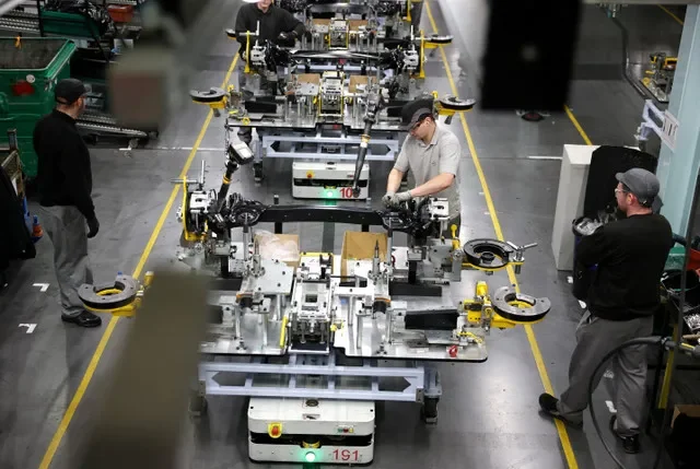 Workers assemble components on the production line for the Qashqai model car at the Nissan car factory in Sunderland, Britain, December 16, 2025.