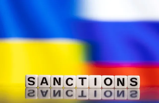 FILE PHOTO: Plastic letters arranged to read "Sanctions" are placed in front of Ukraine's and Russia's flag colors in this illustration taken February 25, 2022. REUTERS/Dado Ruvic/Illustration/ File Photo