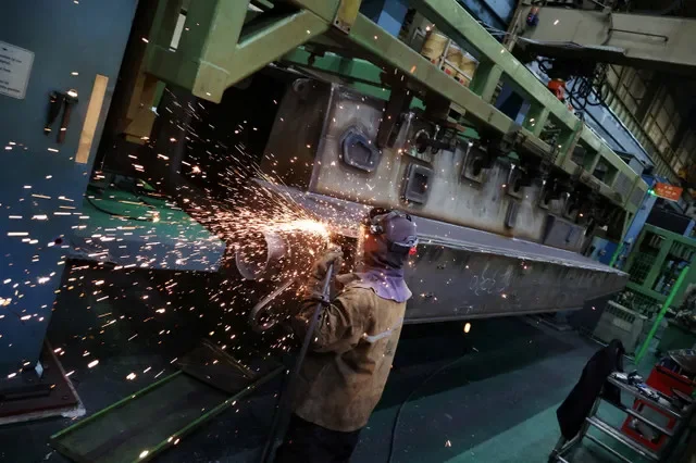 A Hanwha Aerospace engineer works on a KAAV (Korean Amphibious Assault Vehicle) at Hanwha Aerospace factory in Changwon, South Korea, March 16, 2023. REUTERS/Kim Hong-Ji