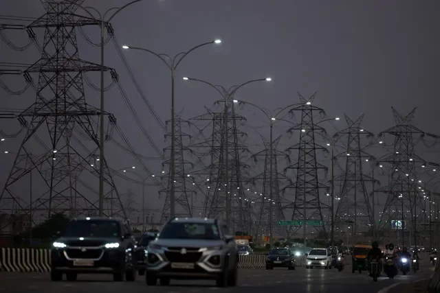 Vehicles move past electricity pylons in Gurugram, India, September 11, 2025. REUTERS/Bhawika Chhabra