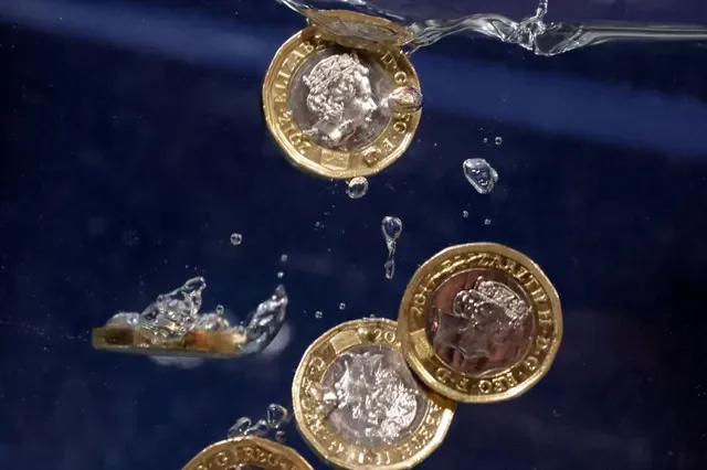 Pound coins plunge into water in this illustration taken, May 23, 2022. REUTERS/Dado Ruvic/Illustration