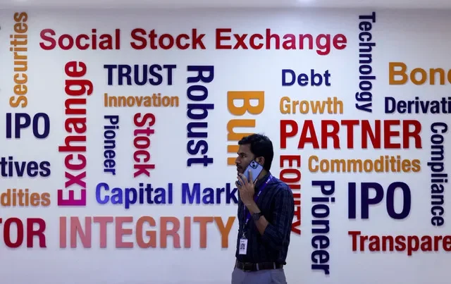 FILE PHOTO: A man speaks on a phone inside the National Stock Exchange (NSE) in Mumbai, India, September 17, 2025. REUTERS/Francis Mascarenhas/File Photo