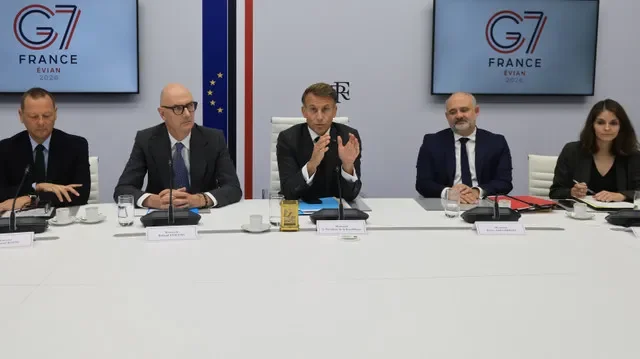 French President Emmanuel Macron (C) speaks next to French Presidential advisor Emmanuel Bonne (L), France's Economy, Finance and Industry Minister Roland Lescure, Secretary-General of the Office of the President of the French Republic Pierre-Andre Imbert and Camille Morfouace de Broucker following a video conference with G7 leaders from the Elysee Presidential Palace in Paris on October 2, 2026.