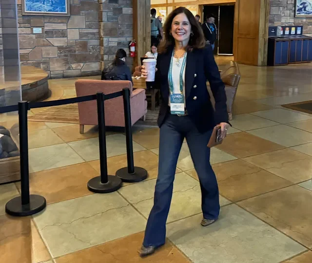 FILE PHOTO: Federal Reserve Bank of Dallas President Lorie Logan walks in to the Jackson Hole Economic Policy Symposium, in Jackson Hole, Wyoming, U.S., August 28, 2026. REUTERS/Ann Saphir/ File Photo