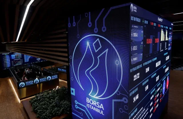 FILE PHOTO: Traders work at their desks on the floor of the Borsa Istanbul in Istanbul, Turkey October 13, 2017. REUTERS/Murad Sezer/File Photo