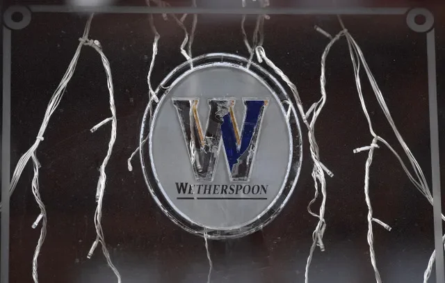 Signage is seen on a window of a closed Wetherspoon pub, as J D Wetherspoon posted its first annual loss since 1984 as coronavirus cases rise in London, Britain, October 16, 2020. REUTERS/Toby Melville