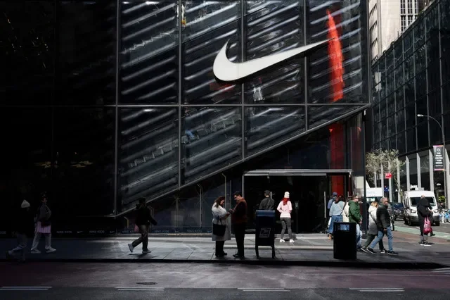 FILE PHOTO: People walk past a Nike store in New York City, U.S., April 2, 2025. REUTERS/Kylie Cooper/File Photo
