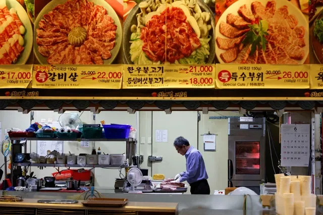 Lee Sang-jae, owner of a meat restaurant, cuts meat at a restaurant in Seoul, South Korea, June 23, 2022. REUTERS/ Heo Ran