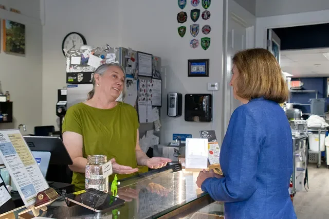 Enna Grazier, the owner of Enna's Chocolate in Exeter, speaks about her Front Street business to Democratic candidate for governor, Cinde Warmington, on Sept. 30, 2026.