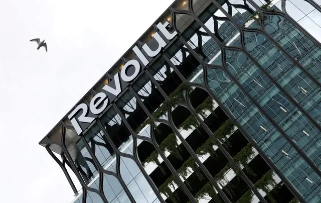 FILE PHOTO: A bird flies past the Revolut global headquarters in Canary Wharf, London, Britain, July 16, 2025. REUTERS/Corey Rudy/File Photo