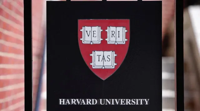 A sign hangs on a gate of a building at Harvard University in Cambridge, Massachusetts, U.S., July 6, 2023. REUTERS/Brian Snyder