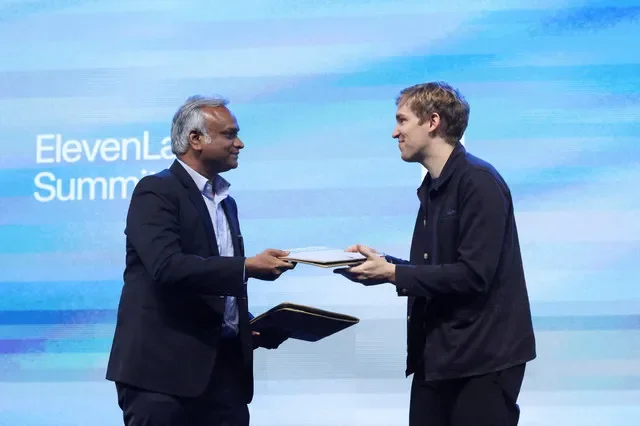 Priyank Kharge, Minister for IT, BT & Rural Development and Panchayat Raj, Government of Karnataka, hands an MOU to Mati Staniszewski, co-founder and CEO of ElevenLabs, during the ElevenLabs Summit in Bengaluru, India, October 6, 2026. REUTERS/Priyanshu Singh