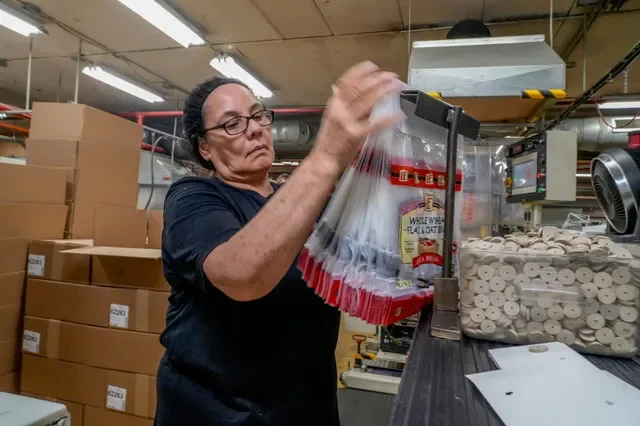 Yesenia Alvarez prepares plastic bags for Admiral Packaging in Providence.