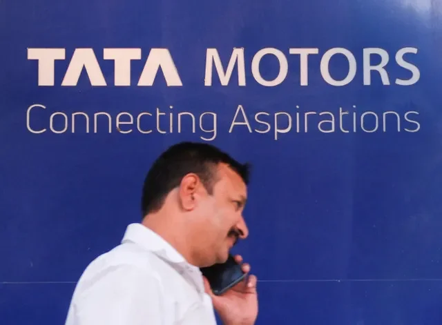 A man speaks on a phone while walking past Tata Motors written outside its showroom in New Delhi, India, September 18, 2026. REUTERS/Sahiba Chawdhary
