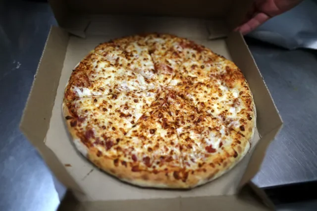 A pizza comes out of the oven at a Domino's Pizza restaurant in Los Angeles.