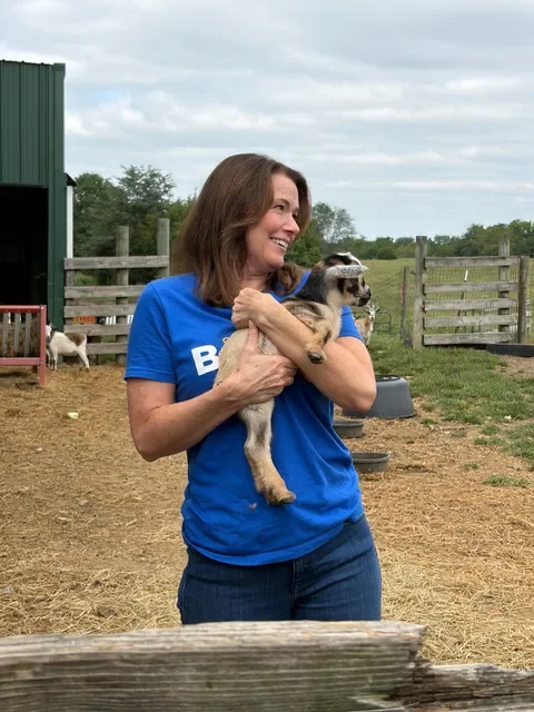 Christina Bohannan, a Democrat from Iowa City, and a candidate for Iowa's 1st Congressional District holds a newborn baby goat before a "meet and greet" in rural Jefferson County on Saturday, Sept. 12, 2026.