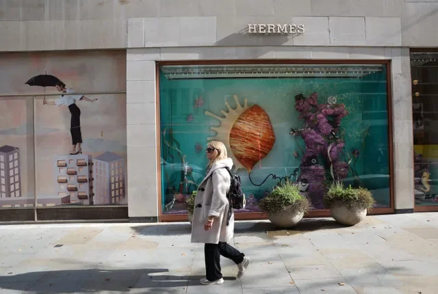 A woman walks past a Hermes shop in the upscale Knightsbridge neighborhood in London, Britain, October 19, 2026. REUTERS/Suzanne Plunkett