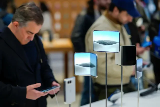 Varios clientes observan el nuevo teléfono plegable iPhone Duo de Apple el día del lanzamiento en la tienda insignia de Apple en la Quinta Avenida de Nueva York, Estados Unidos, el 23 de octubre de 2026. REUTERS/Eduardo Munoz