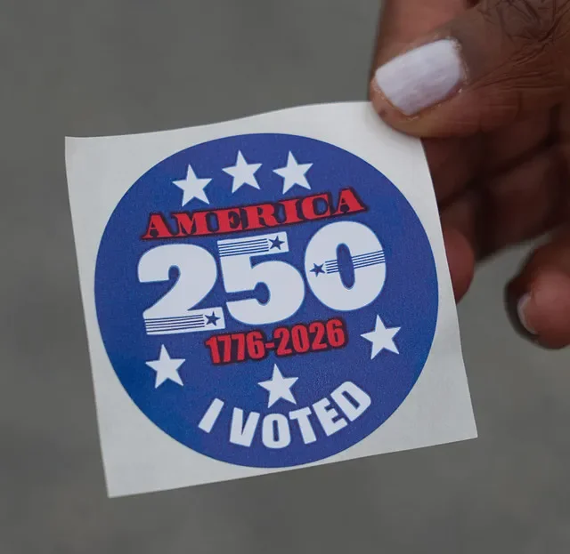 A voter shows their 'I voted' sticker after casting their ballot in Delaware's Primary Election on September 2, 2026.
