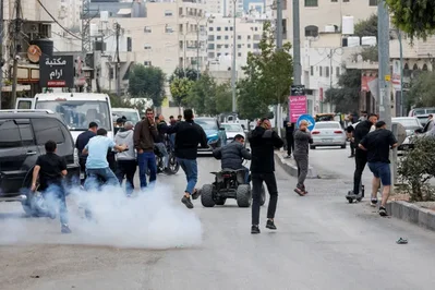Israeli troops fired a stun grenade to disperse Palestinian protesters demonstrating against military demolitions in Hebron. The unrest unfolded as Israelis cast ballots in a national election.