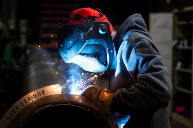 FILE PHOTO: A worker welds a steel tube at HCC, a company that uses parts to make combines, at the factory in Mendota, Illinois, U.S., February 21, 2025. REUTERS/Vincent Alban/ File Photo