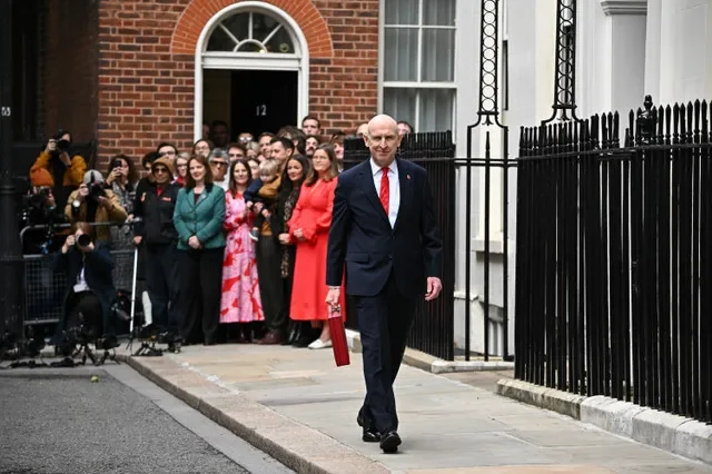 2026年10月28日,英國倫敦,英國財政大臣約翰·希利手提傳統的紅色大臣公文包離開唐寧街11號,前往下議院發表安迪·伯納姆首相政府任內的首份預算案。路透社/迪倫·馬丁內斯/聯合採訪團